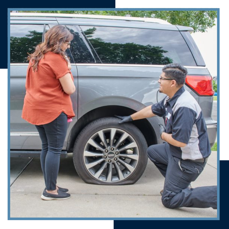 SJ Tire Co employee with flat tire